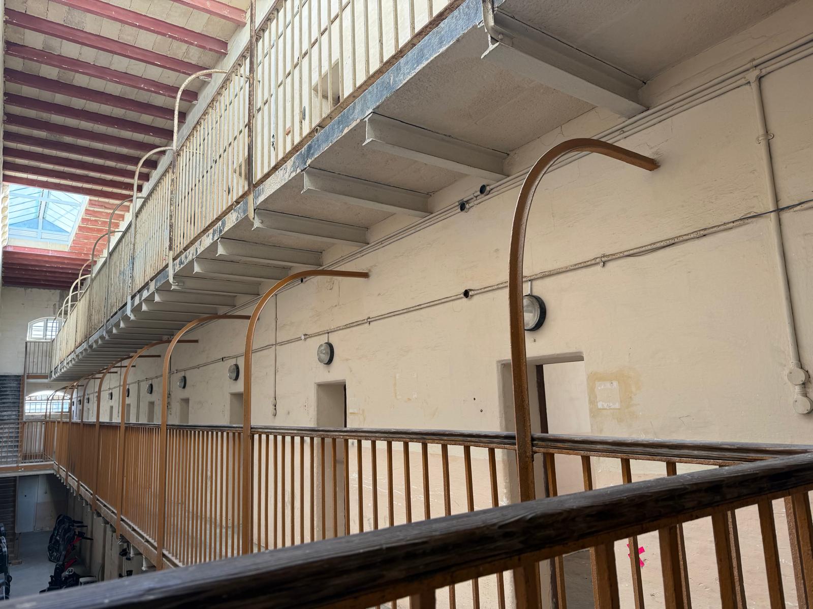Iron railings and limestone walls in the original prison galleries